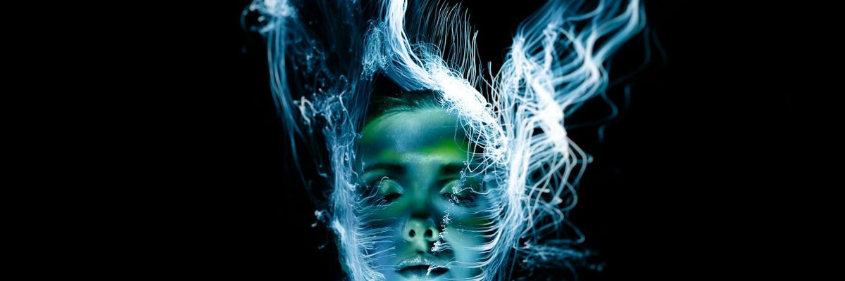 A long exposure shot showing the fluid motion of a person practicing yoga.